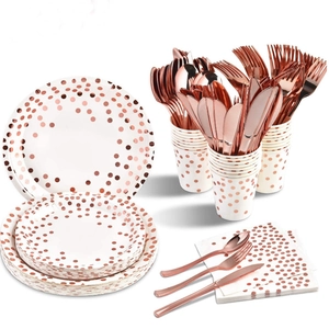 Detail of rose gold polka dot party tableware set including plates, cups, and napkins