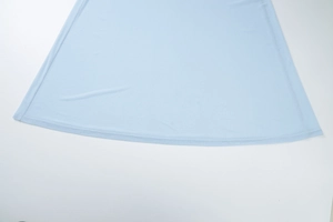 Close-up of light blue mesh fabric showing refined double-needle hem stitching detail