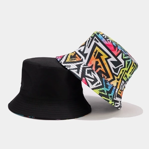 Reversible cotton bucket hat with classic solid black and vibrant graffiti patterns