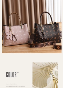 Detail of elegant patterned handbags in pink beige and dark brown with floral charms