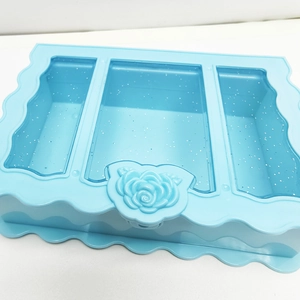 Macro view of light blue jewelry box featuring 3 compartments and floral glitter lid