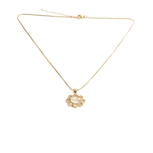 Macro detail of gold sun-shaped MAMA pendant with colorful zircons on a delicate chain