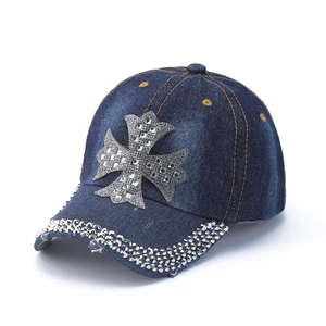 Dark blue denim baseball cap featuring silver rhinestone cross and studded brim accents