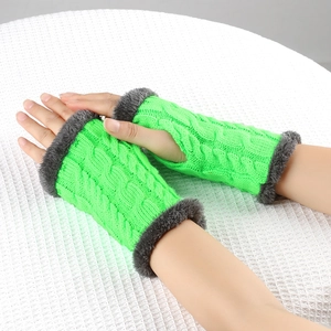 Detail of bright green cable knit fingerless gloves with grey faux fur trim and soft lining