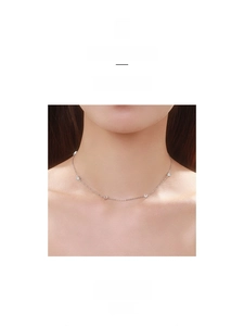 Close-up of S925 silver necklace with heart charms worn by a model in elegant style