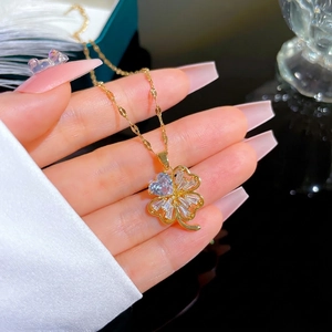 Luxurious gold four-leaf clover necklace with blue heart zircon and clear crystals