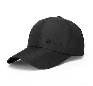 Close-up of the side embroidery Classic on a black baseball cap with mesh texture