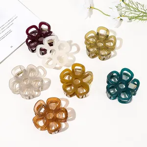 Flat lay of colorful hollow flower hair claws in resin and acrylic on white background