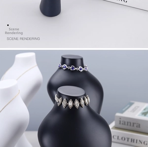 Detail view of minimalist black and white portrait bust stands for necklace display