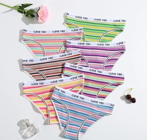 Detailed flat lay of seven ribbed cotton panties with colorful stripes and love prints
