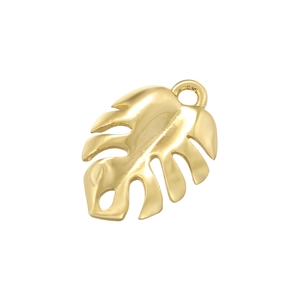 Macro view of a gold monstera leaf pendant with a polished finish and top ring