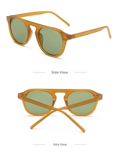 Detail view of orange translucent resin frame sunglasses with silver rivets and green lenses
