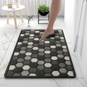 Detail of geometric honeycomb diatom mud bath mat with non-slip edge in bathroom