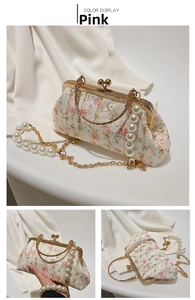 Detailed view of pink floral embroidery, pearl handle, and vintage metal clasp bag