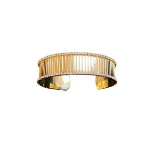 Gold-plated striped open cuff bracelet with dual rows of micro-pave crystals on edges