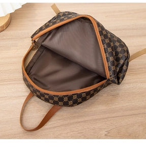 Top view of open dark brown floral backpack interior showing lining and zipper detail