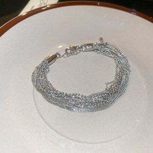 Detail view of silver multi-layer layered chain bracelet with adjustable extender chain