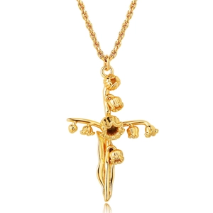 Macro detail of gold lily of the valley cross pendant with realistic flower and leaf texture