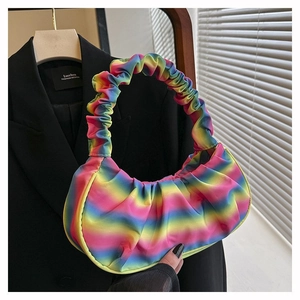 Detail view of rainbow gradient pleated shoulder bag with unique cloud shape and texture