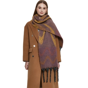Thick faux mohair scarf with purple wave patterns and black tassels on a brown coat