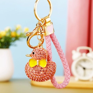 Detail of pink rhinestone duck keychain with gold ring and pink woven leather strap