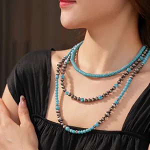 Bohemian multilayered necklace with turquoise beads and vintage silver accents on a model