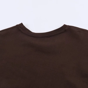 Detail of a dark brown T-shirt showing high-density cotton fabric and double-needle stitching
