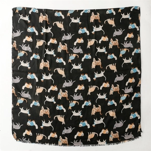 Detail of square black scarf with cartoon cat patterns and delicate fringe edges