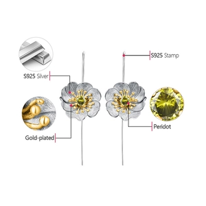 Detail view of S925 sterling silver flower earrings with peridot and gold plating