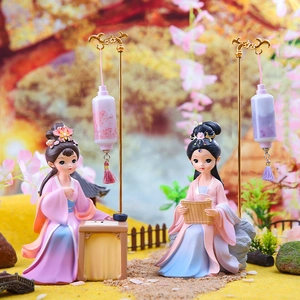Detailed view of classical Chinese lady figurines in hanfu with miniature lanterns