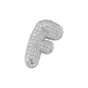 Macro shot of silver letter F pendant with pave-set cubic zirconia in bubble font style