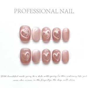 Handmade dusty pink cat-eye press-on nails with magnetic heart pattern and glossy finish