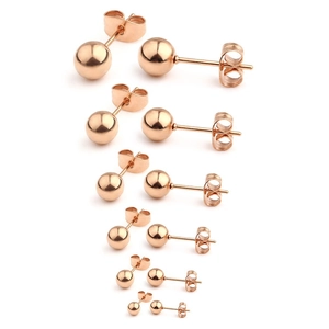 Detail of six pairs of rose gold stainless steel ball stud earrings in graduated sizes
