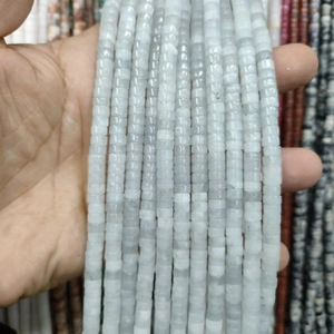 Close-up of light green natural stone cylinder beads for DIY jewelry making