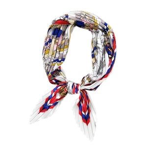 Pleated square silk scarf featuring nautical prints and vibrant red and blue geometric patterns