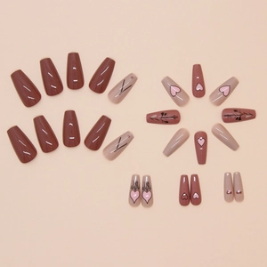 Chocolate and nude press-on nails with heart and leaf patterns in coffin shape