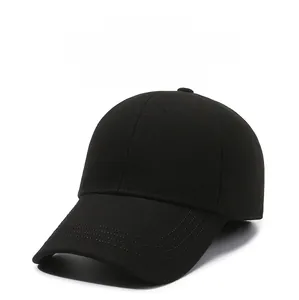 Detail of black baseball cap showing 3D VISITOR embroidery on thick winter fabric