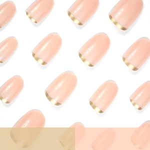 Short oval press-on nails with nude base and metallic gold French tip design