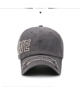 Detail of grey washed cotton baseball cap featuring LIVE embroidery and vintage brim patch
