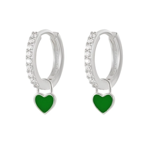 Close-up of silver hoop earrings with clear crystals and green heart pendants