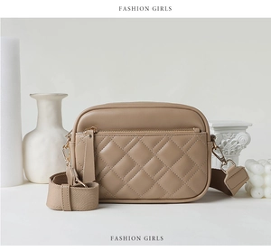 Detail of khaki quilted crossbody bag with adjustable strap and golden hardware