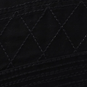 Detailed close-up of black cotton fabric with quilted diamond pattern stitching for berets