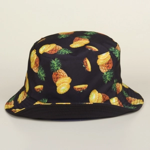 Close-up of black fisherman hat featuring vibrant pineapple and pineapple slice patterns