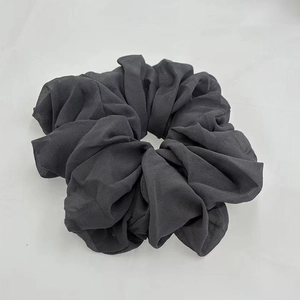 Detail of dark grey elastic scrunchie with high-quality textured chiffon fabric