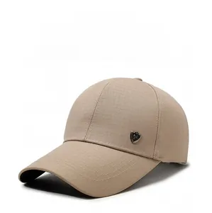 Detail of khaki baseball cap featuring micro-grid texture and metal shield logo