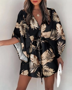 Detail of V-neck dress with golden leaf print, wide sleeves and adjustable waist tie