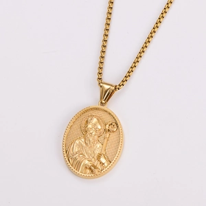 Detail of a golden oval pendant with saint relief and box chain on white background
