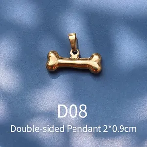 Detail of 18K gold plated bone-shaped pendant with 2x0.9cm dimensions and double-sided design