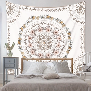 Close-up of mandala tapestry pattern showing warm floral textures in a bohemian bedroom