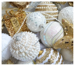 Detailed close-up of champagne gold and white Christmas ornaments with glitter and pearls